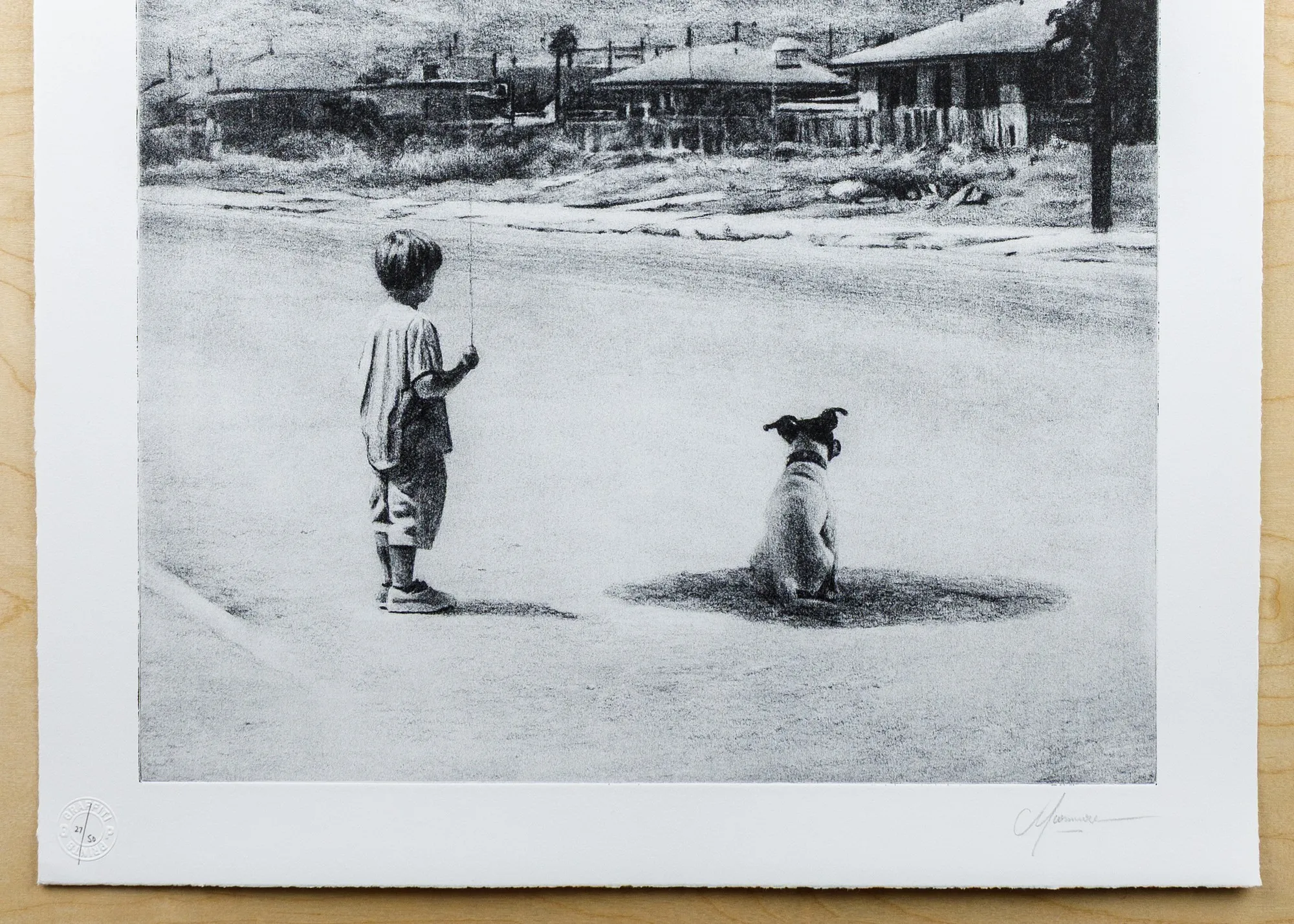The lower portion of a charcoal-grey etching showing a boy and a dog in an empty street, above a white margin bearing a pencil fraction "27/50" with a round embossed stamp pressed over it at left, and a pencil signature at right.