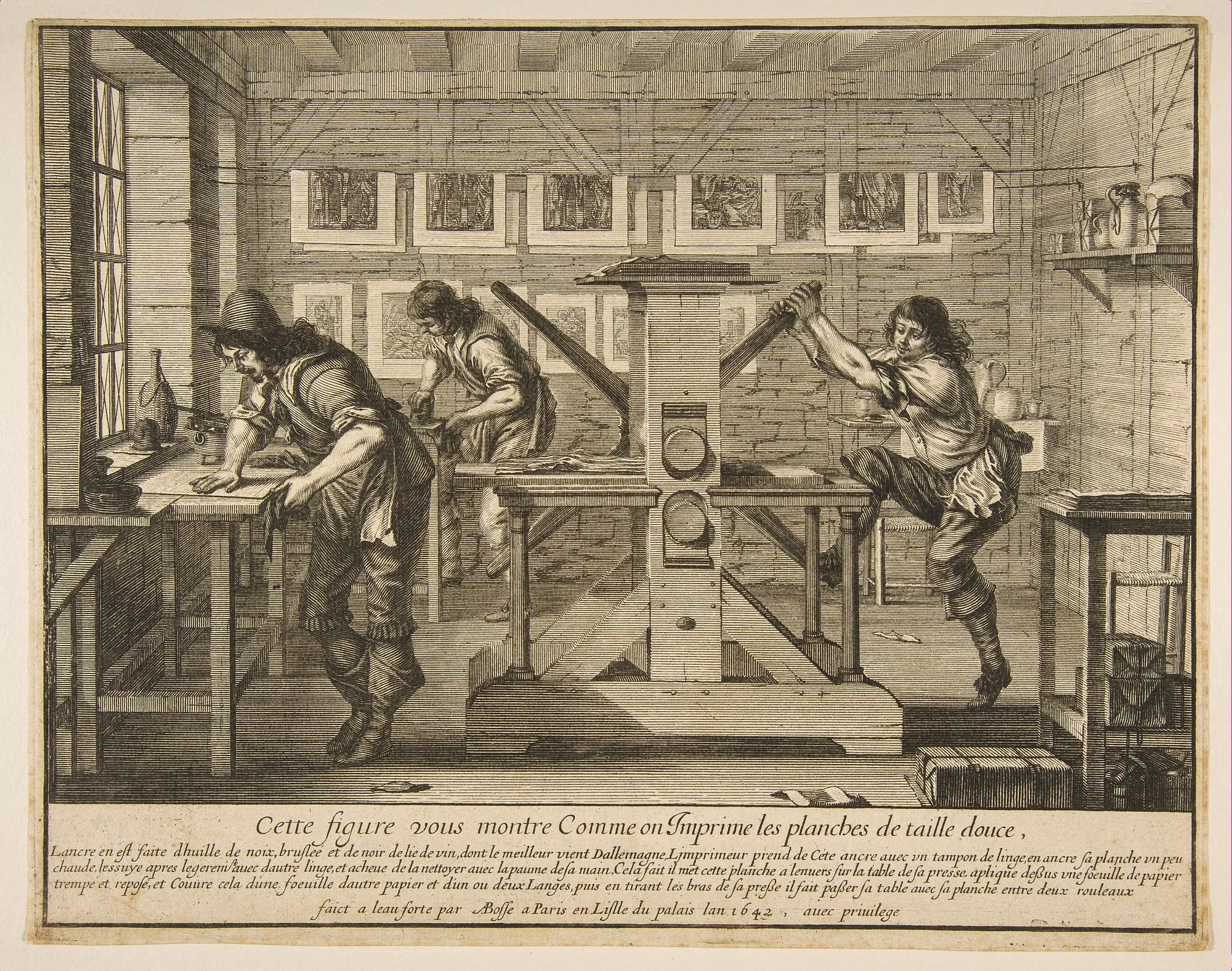 A seventeenth-century workshop scene: one printer inks a metal plate while another runs the intaglio rolling press.