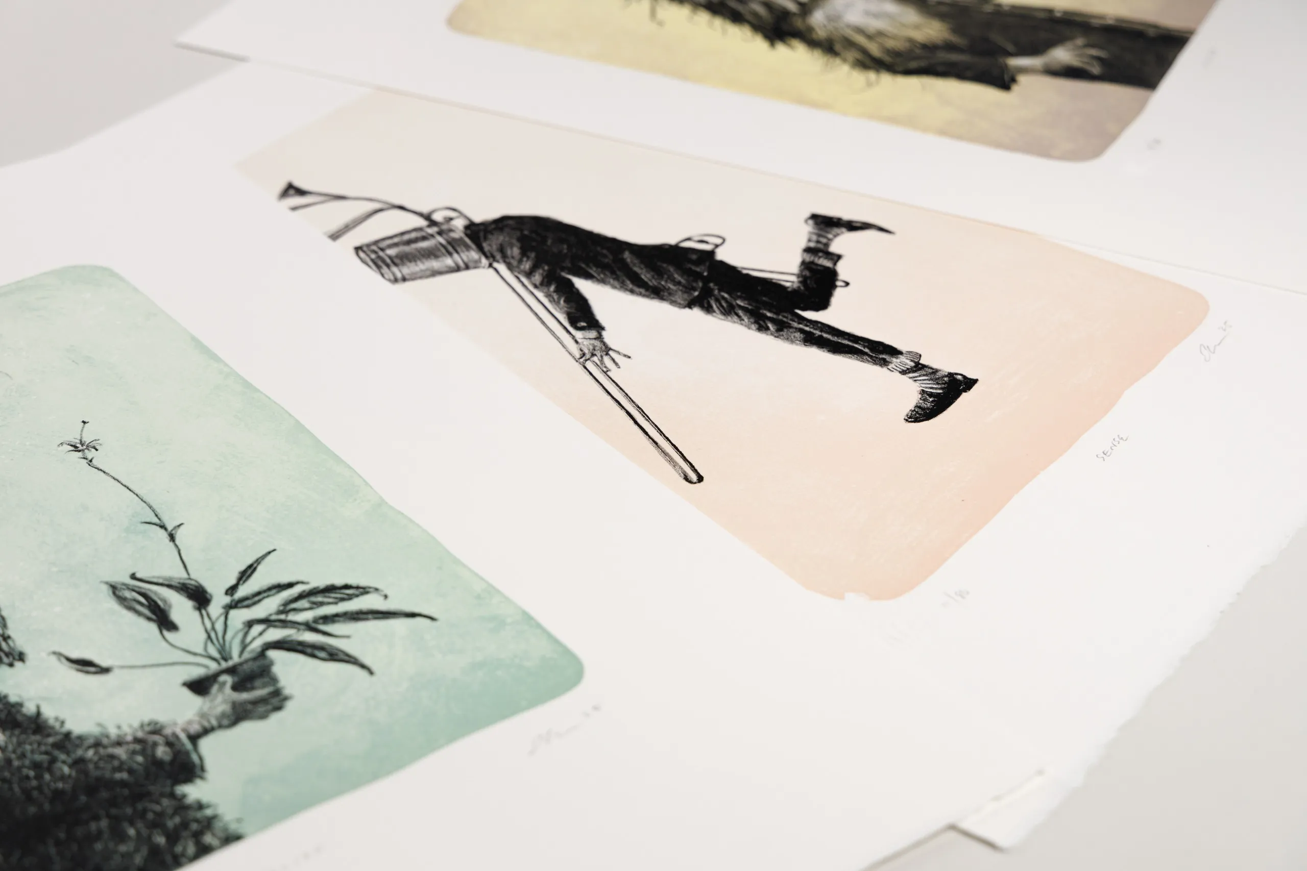 Three lithograph prints displayed together.