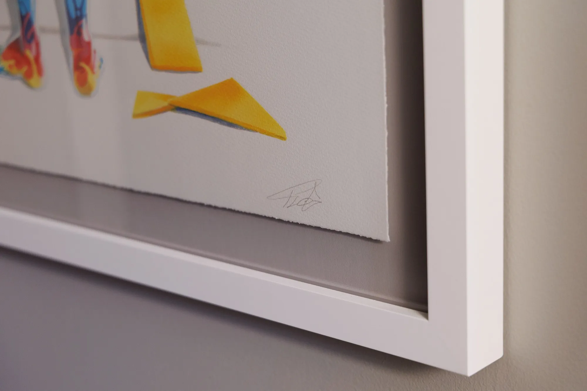 Close-up of the lower right corner of the deckled sheet, showing FLOG's pencil signature in the margin below two yellow shards.