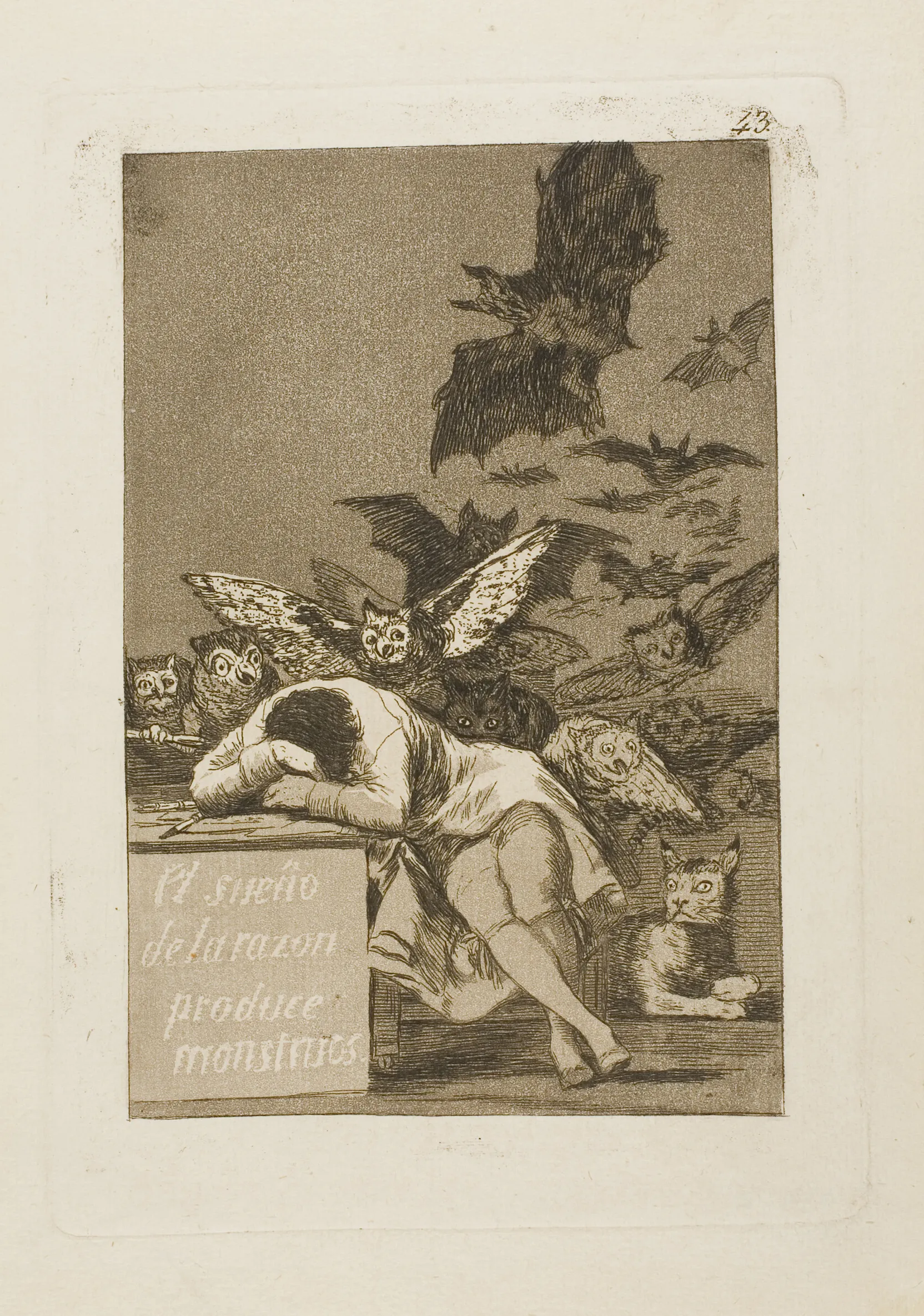 A sepia aquatint etching by Goya: a man slumped asleep over a desk as owls and bats swarm out of the darkness behind him; a title is lettered along the front of the desk.