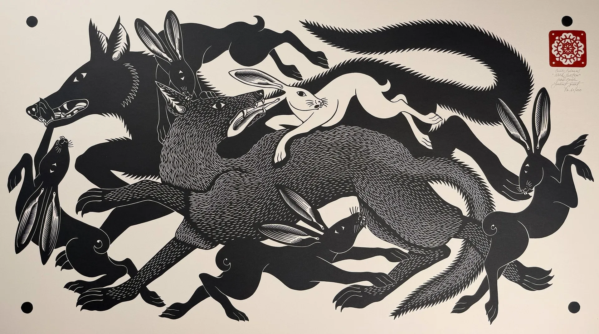 A wolf and hares locked together in dense black across a wide sheet, the animals' coats built from fine parallel white cuts.