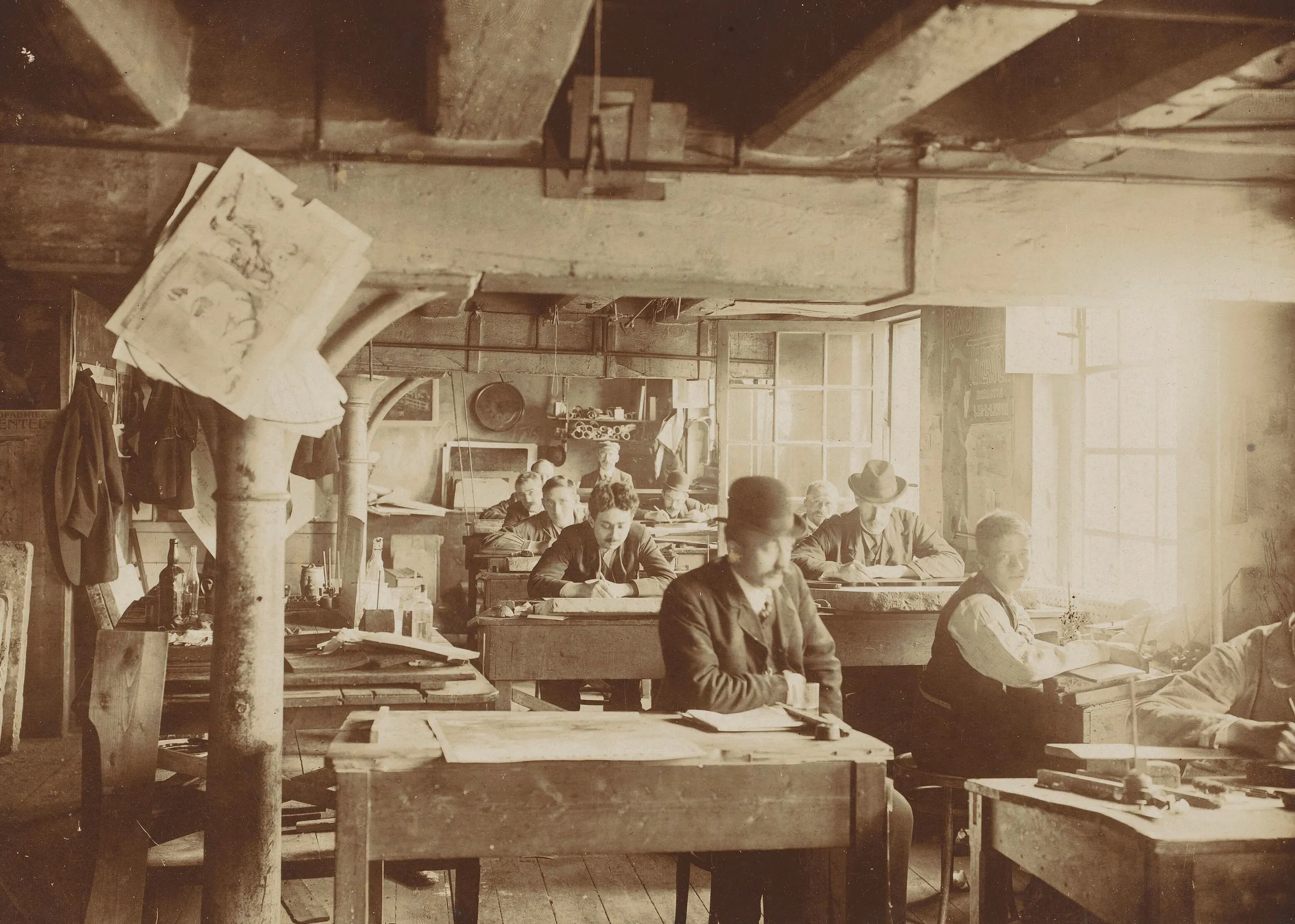 A photograph of a 19th-century lithography workshop, with draughtsmen at work.