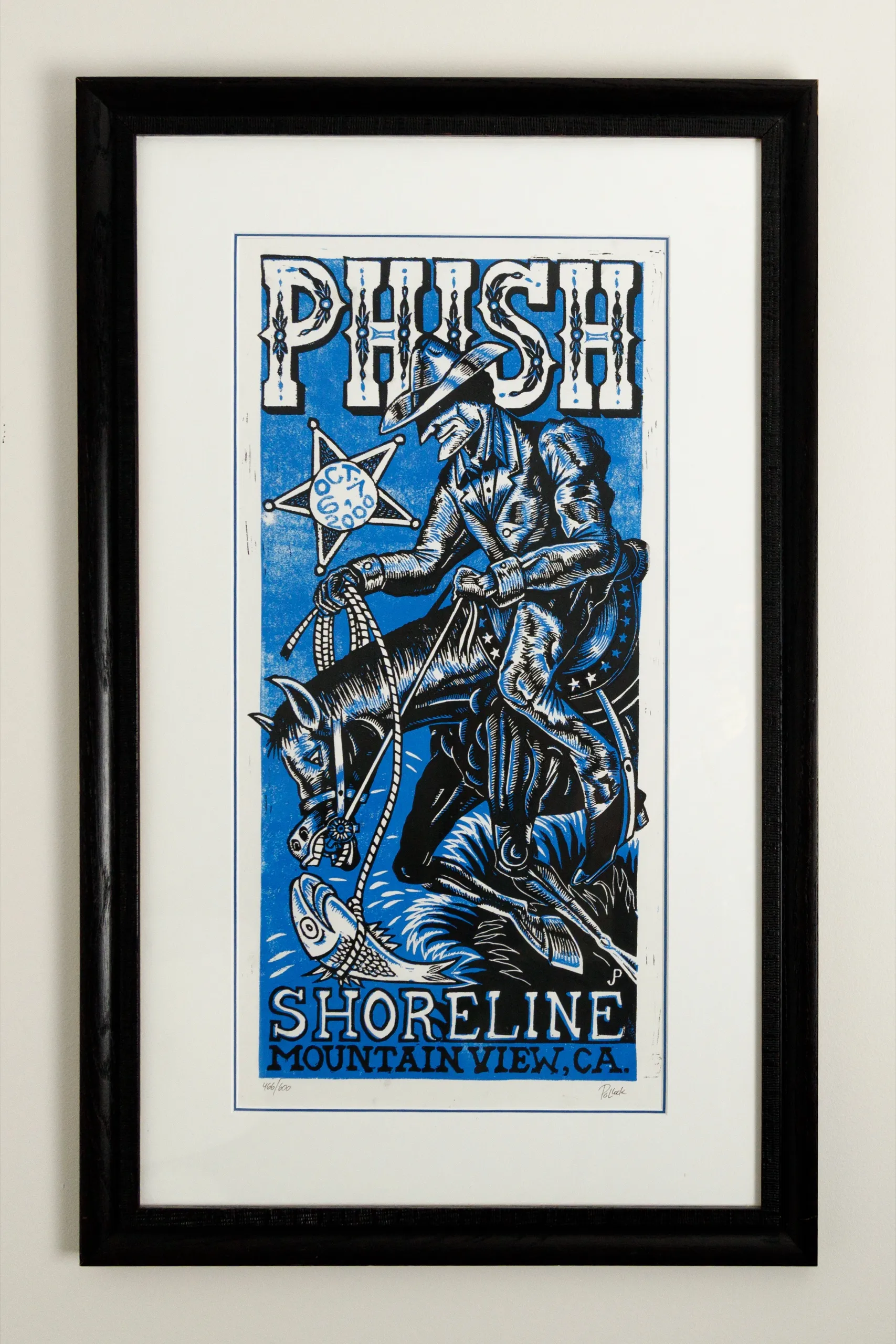 A framed linocut print.